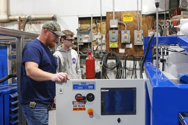 Don Thompson (left) and Mathew Corbell (right) inspect a dry ice machine on Wednesday, December 2, 2020, at the headquarters of TOMCO2 Systems, a dry ice equipment manufacturer in Loganville, Georgia. The company is gearing up for a potential increase in demand due to the distribution of the COVID-19 vaccine. CHRISTINA MATACOTTA FOR THE ATLANTA JOURNAL-CONSTITUTION