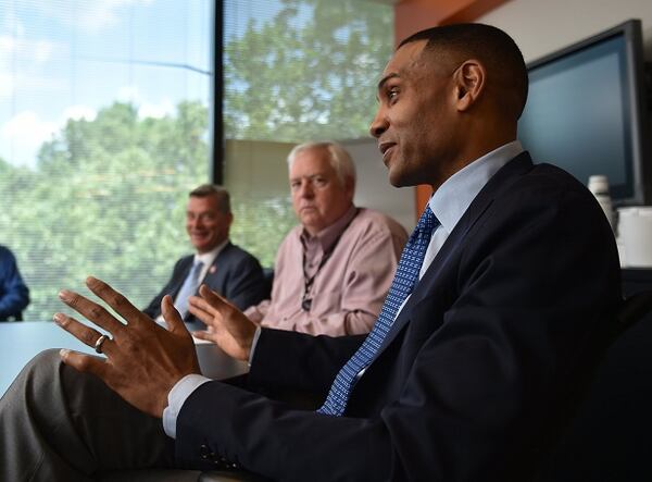 Here's Tony Ressler, AJC editor Kevin Riley and Grant Hill. (Brant Sanderlin/AJC photo)