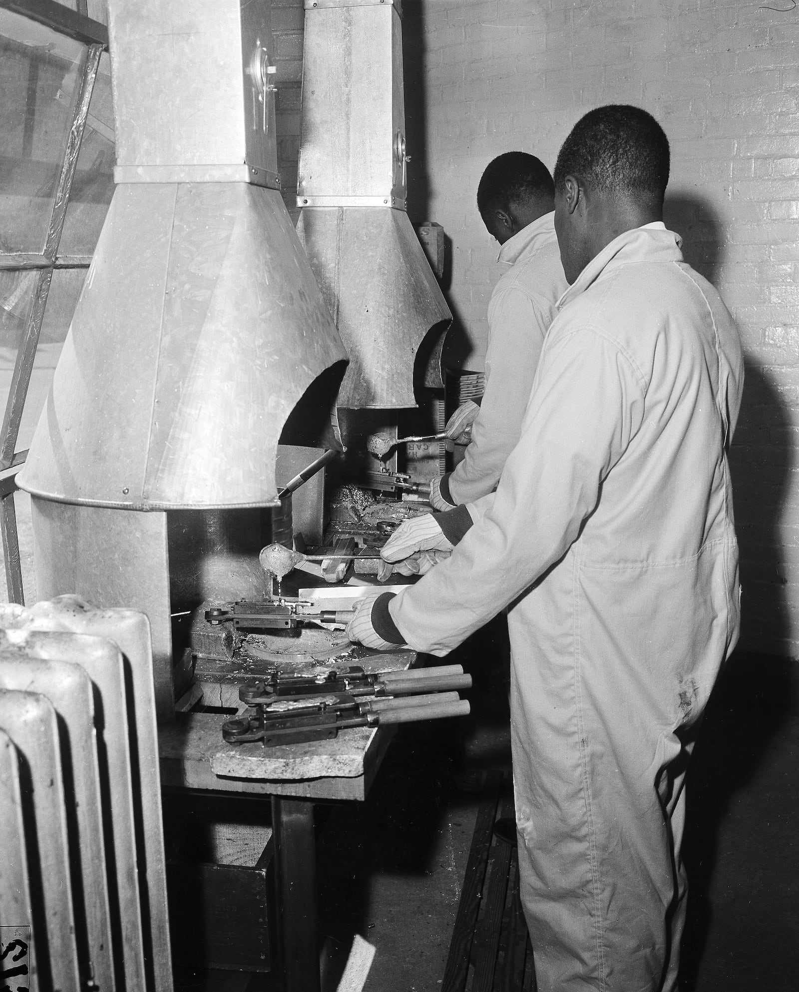 FILE - Inmates at the maximum security Holmesburg Prison in Philadelphia, turn out bullets for police revolvers, April 16, 1957. (AP Photo/Bill Ingraham, File)