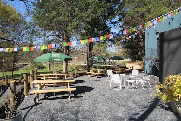 The rear patio, also known as the Backyard, at the Best Sandwich Shop and Wurst Beer Hall. The Wurst space has an oak bartop made with reclaimed wood from Piedmont Park, flags and banners from sports teams, televisions showing U.S. and European sports. / Courtesy of the Best Sandwich Shop