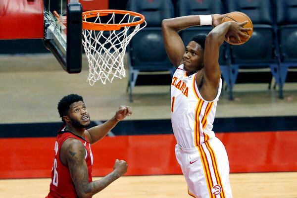 Atlanta Hawks forward Nathan Knight (1) dunks the ball as Houston Rockets center Justin Patton, left, looks on during the first half of an NBA basketball game Tuesday, March 16, 2021, in Houston. (AP Photo/Michael Wyke)