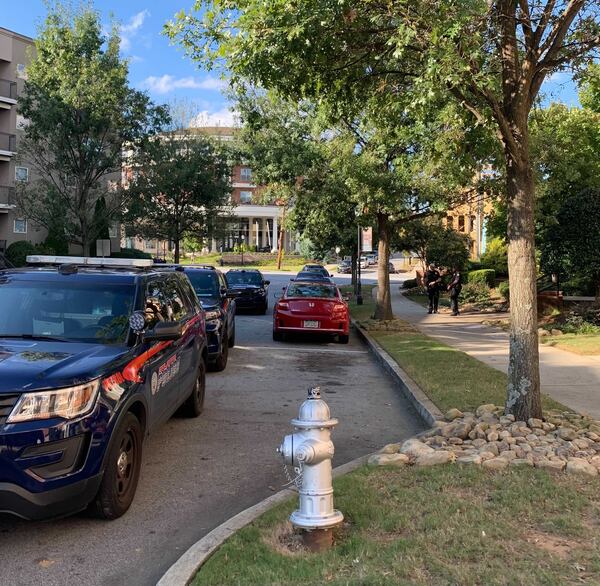 Atlanta police patrol cars gathered outside of the Sorelle Apartments after a man was found dead inside.