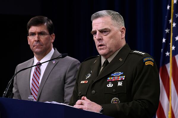 Defense Secretary Mark Esper, left, and Chairman of the Joint Chiefs of Staff Army Gen. Mark Milley discuss plans to withdraw troops from Afghanistan.