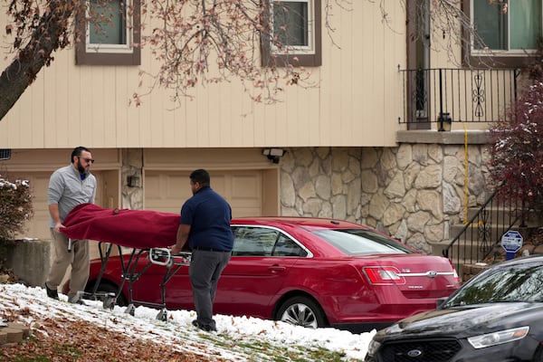 Workers carry a body from the home of former Kansas City, Kan. police detective Roger Golubski on Monday, Dec. 2, 2024, in Edwardsville, Kan. (AP Photo/Charlie Riedel)