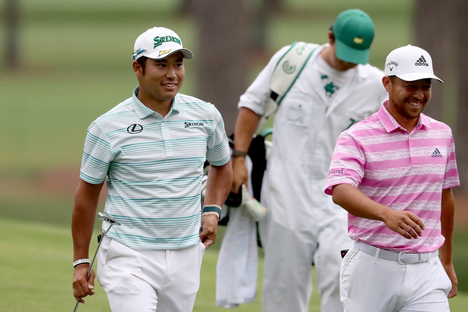 April 10, 2021, Augusta: Hideki Matsuyama, left, reacts after making an eagle on the fifteenth hole with Xander Schauffele during the third round of the Masters at Augusta National Golf Club on Saturday, April 10, 2021, in Augusta. Curtis Compton/ccompton@ajc.com