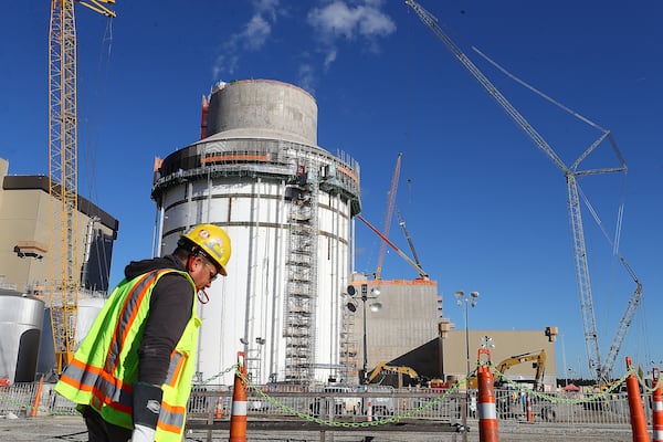 Waynesboro: One of thousands of construction workers passes by the exterior work on Unit 4 (the second new reactor area) at Georgia Power's Plant Vogtle expansion on Tuesday, Dec 14, 2021, south of Augusta. Curtis Compton / Curtis.Compton@ajc.com