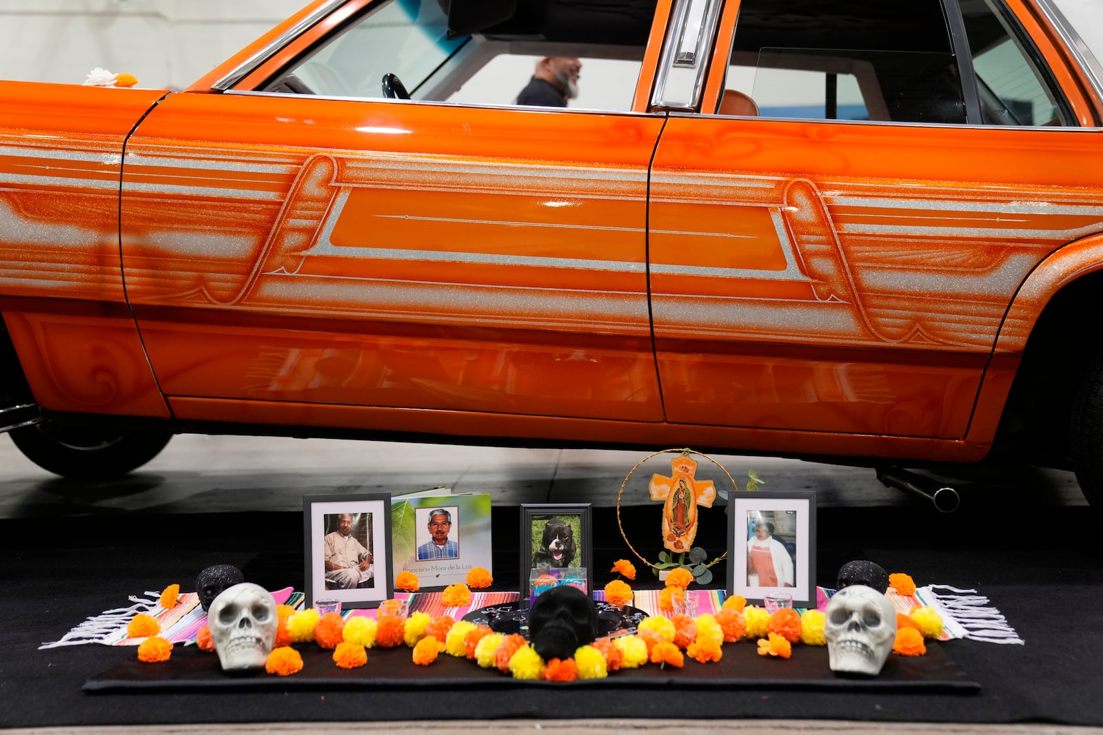 A Day of the Dead altar is placed next to a lowrider car on display at the Slow & Low Chicago Lowrider Festival, Saturday, Oct. 12, 2024, at Navy Pier in Chicago. (AP Photo/Erin Hooley)