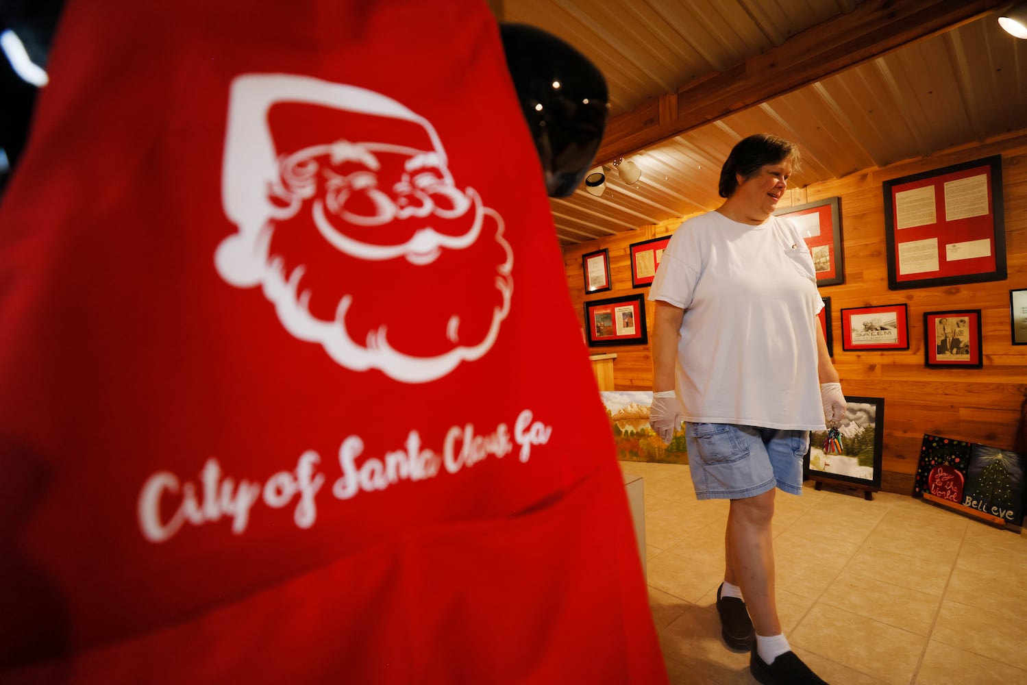 Santa Claus City mayor Donita Bowens walks inside the gift shop that opens to the public Monday through Friday, 9 a.m. to 2 p.m. You can find t-shirts, coffee mugs, and other items with the city's name. In addition, inside the building is a small museum with photographs of the town's history.
 Miguel Martinez / miguel.martinezjimenez@ajc.com