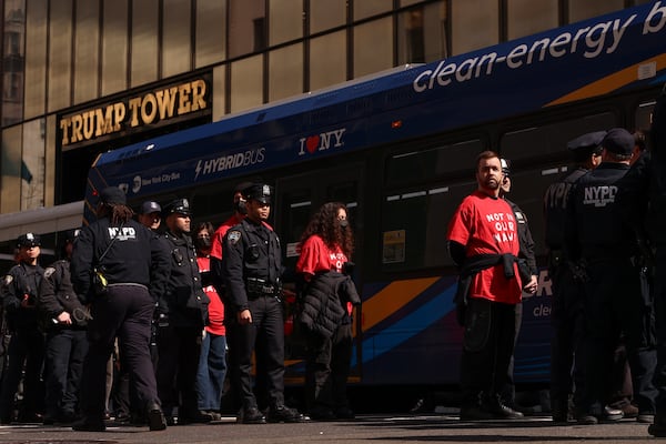 Demonstrators from the group, Jewish Voice for Peace, who were arrested while protesting inside Trump Tower, wait to board a bus escorted by New York Police officers, Thursday, March 13, 2025, in New York. (AP Photo/Yuki Iwamura)