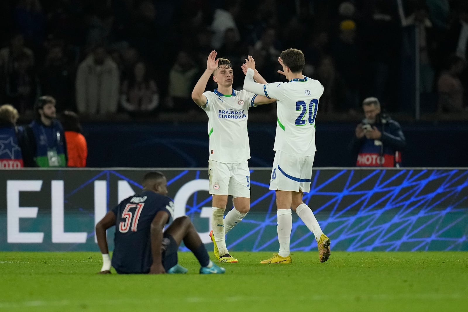 PSV players perform a high five after the Champions League opening phase soccer match between Paris Saint-Germain and PSV Eindhoven at the Parc des Princes stadium in Paris, France, Tuesday, Oct. 22, 2024. (AP Photo/Christophe Ena)