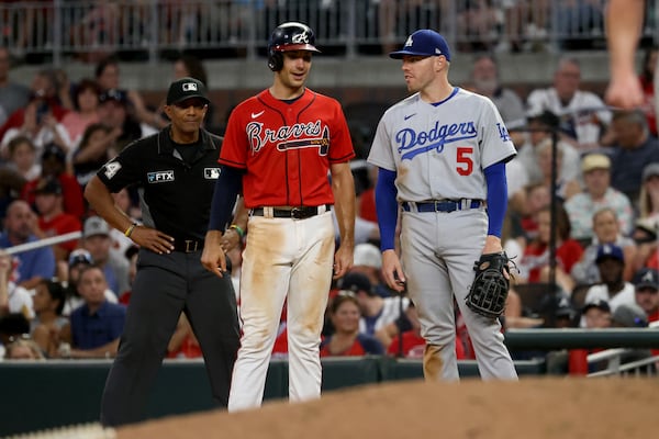 Los Angeles Dodgers first baseman Freddie Freeman, right, talk with Atlanta Braves first baseman Matt Olson after Olson hit a single during the ninth inning at Truist Park Friday, June 24, 2022, in Atlanta. (Jason Getz / Jason.Getz@ajc.com)