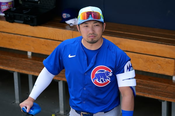 Chicago Cubs' Seiya Suzuki, of Japan, pauses in the dugout prior to a spring training baseball game against the Arizona Diamondbacks, Monday, March 3, 2025, in Scottsdale, Ariz. (AP Photo/Ross D. Franklin)