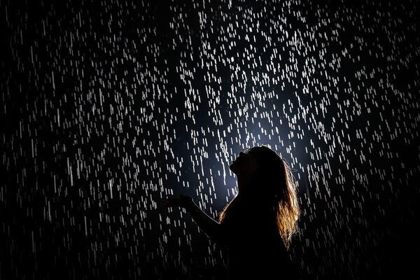 A visitor walks through and experiences "Rain Room" at Shanghai Yuz Museum on August 31, 2105 in Shanghai, China. 