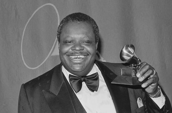 Jazz pianist Oscar Peterson poses with his Grammy for best jazz instrumental performance at the 21st annual Grammy Awards presentation in Los Angeles, Ca., on Feb. 16, 1979.  (AP Photo/Lennox McLendon)