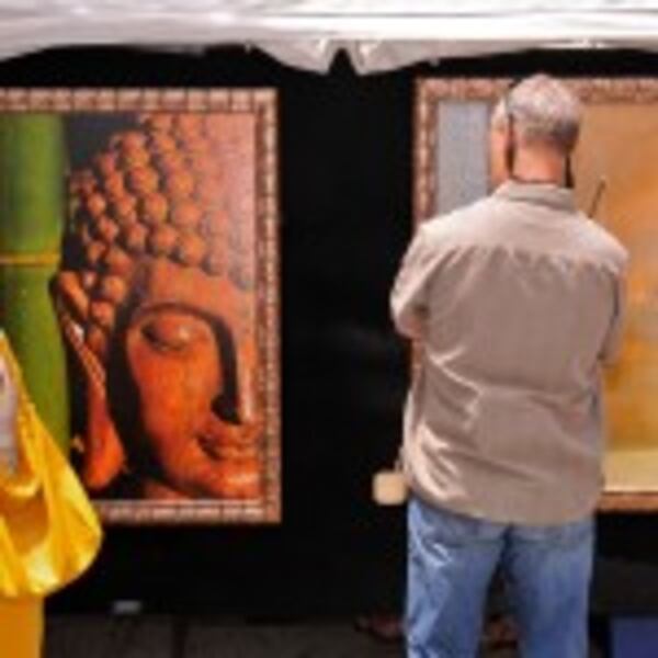 A festival-goer at Decatur Arts Festival admires the wares. CONTRIBUTED BY DECATUR ARTS FESTIVAL