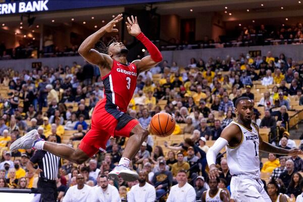 Georgia's Kario Oquendo, left, has the ball knocked away by Missouri's Amari Davis, right, while attempting a shot during the first half of an NCAA college basketball game Saturday, March 5, 2022, in Columbia, Mo. (AP Photo/L.G. Patterson)