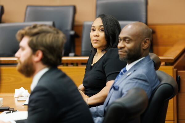 District Attorney Fani Willis (center) reacts to proceedings at Fulton County Superior Court on Thursday, July 21, 2022.  Willis expects to announce indictments in her election meddling probe this summer. (Arvin Temkar / arvin.temkar@ajc.com)