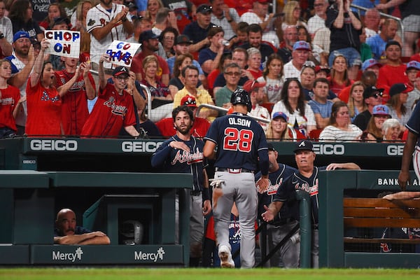 Atlanta Braves' Matt Olson (28) is congratulated by teammates after scoring a run in the fourth inning of a baseball game against the St. Louis Cardinals on Friday, Aug. 26, 2022, in St. Louis. (AP Photo/Joe Puetz)