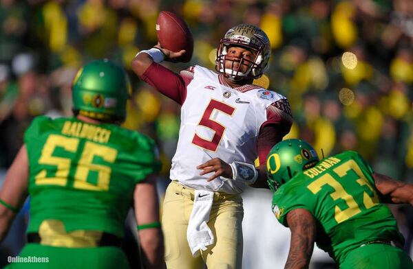 Florida State quarterback Jameis Winston, center, looks to pass under pressure by Oregon defensive lineman Alex Balducci, left, and Tyson Coleman during the first half of the Rose Bowl NCAA college football playoff semifinal, Thursday, Jan. 1, 2015, in Pasadena, Calif. (AP Photo/Mark J. Terrill)