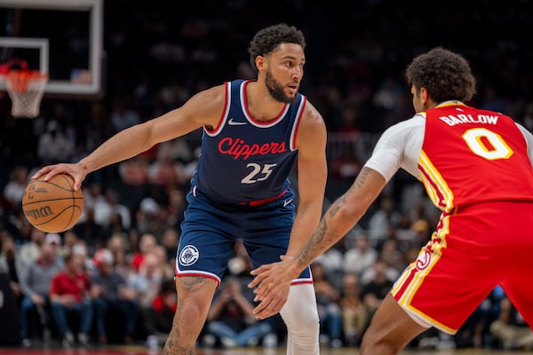 Los Angeles Clippers guard Ben Simmons (25), left, attempts to pass the ball against Atlanta Hawks forward Dominick Barlow (0), right, during the first half of an NBA basketball game, Friday, March 14, 2025, in Atlanta. (AP Photo/Erik Rank)