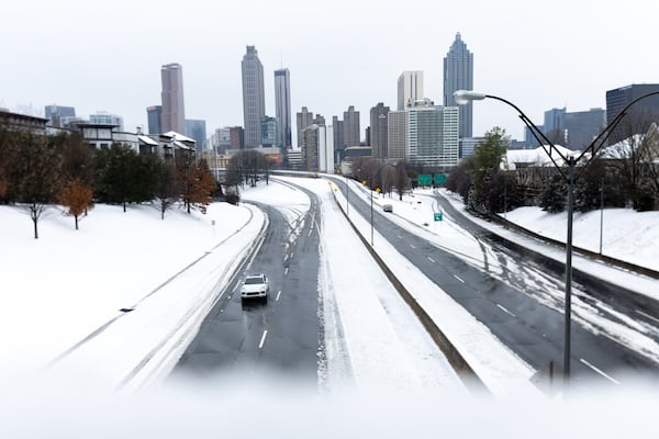 A view of the Atlanta skyline at Jackson Street Bridge in Atlanta on Friday, January 10, 2025. Snow is covering metro Atlanta on Friday morning as a winter storm bears down across North Georgia.  (Arvin Temkar / AJC)