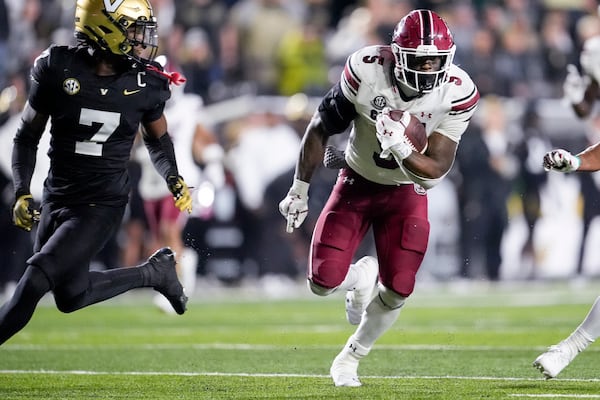 South Carolina running back Raheim Sanders (5) runs the ball past Vanderbilt safety Marlen Sewell (7) during the second half of an NCAA college football game Saturday, Nov. 9, 2024, in Nashville, Tenn. (AP Photo/George Walker IV)