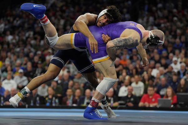 Penn State's Carter Starocci, top, takes on Northern Iowa's Parker Keckeisen during a 184-pound match in the finals at the NCAA wrestling championship, Saturday, March 22, 2025, in Philadelphia. (AP Photo/Matt Rourke)