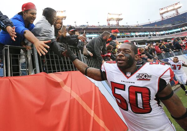 102515 NASHVILLE: -- Falcons O’Brien Schofield (left) and Ricardo Allen high five Falcons fans after beating the Titans 10-7 in a football game on Sunday, Oct. 25, 2015, in Nashville. Curtis Compton / ccompton@ajc.com