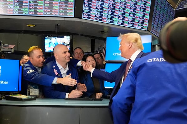 President-elect Donald Trump is greeted by traders, as he walks the floor of the New York Stock Exchange, Thursday, Dec. 12, 2024, in New York. (AP Photo/Alex Brandon)