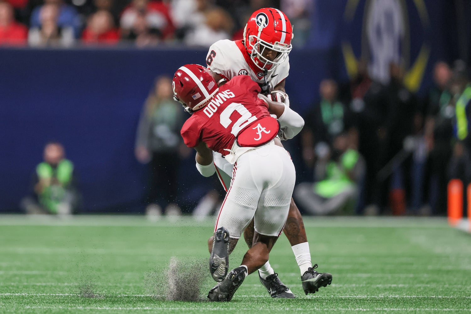 Georgia Bulldogs wide receiver Dominic Lovett (6) runs into Alabama Crimson Tide defensive back Caleb Downs (2) during the first half of the SEC Championship football game at the Mercedes-Benz Stadium in Atlanta, on Saturday, December 2, 2023. (Jason Getz / Jason.Getz@ajc.com)