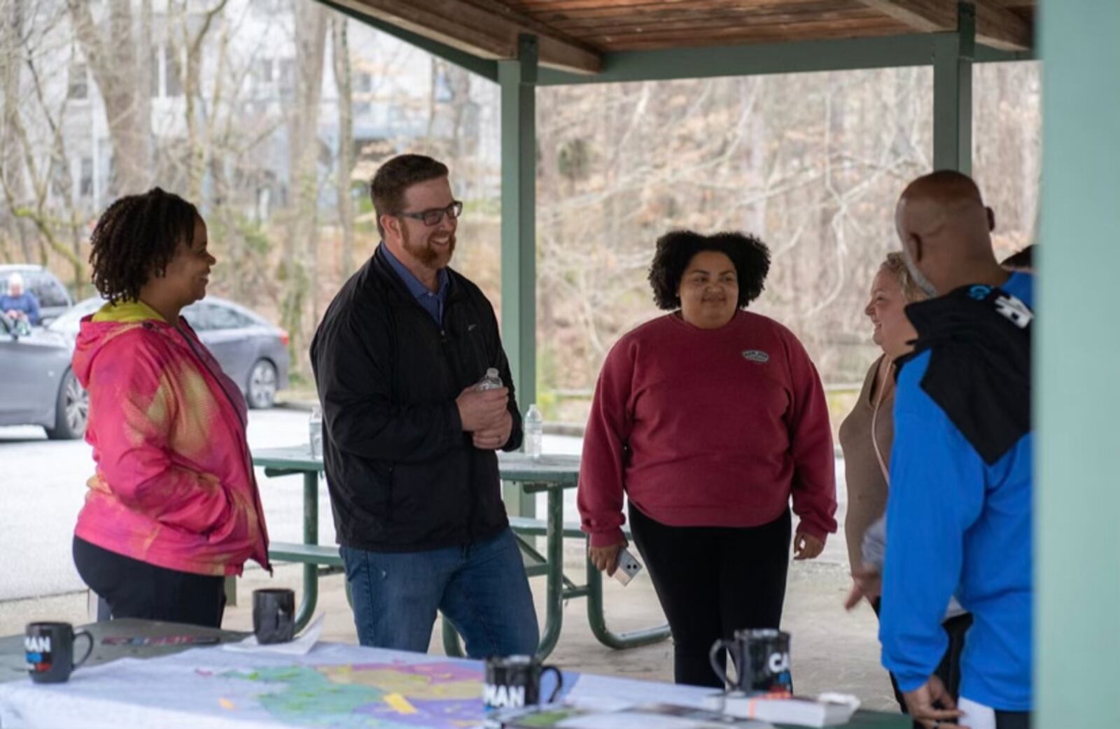 Aaron Carman (center), candidate for Mableton mayor, talks with residents at a campaign event. Provided by Aaron Carman