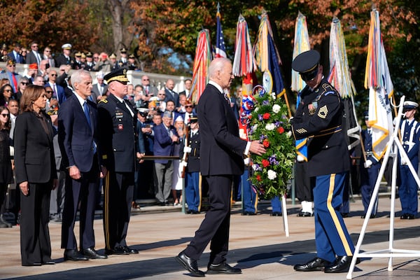 President Joe Biden, second from right, lays a wreath at the Tomb of the Unknown Soldier as Vice President Kamala Harris, from left, Veterans Affairs Secretary Denis McDonough and Maj. Gen. Trevor Bredenkamp, commanding general of the Joint Task Force-National Capital Region and the U.S. Military District of Washington, watch, on National Veterans Day Observance at Arlington National Cemetery in Arlington, Va., Monday, Nov. 11, 2024. (AP Photo/Mark Schiefelbein)