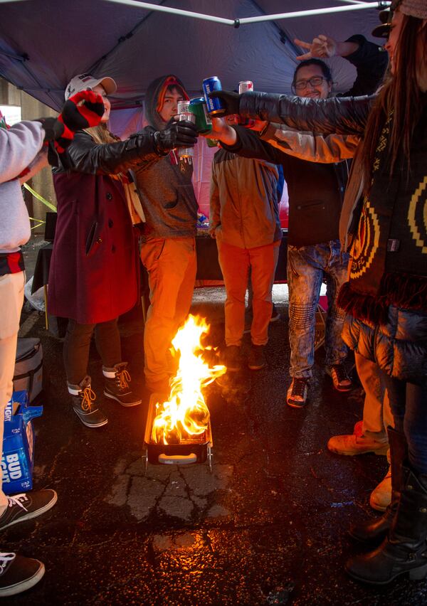 Fans try and stay warm around a fire while tailgating in the Gultch before the start of the MLS championship game between the Portland Timbers and the Atlanta United FC Saturday, November 8, 2018, in Atlanta GA.  STEVE SCHAEFER / SPECIAL TO THE AJC