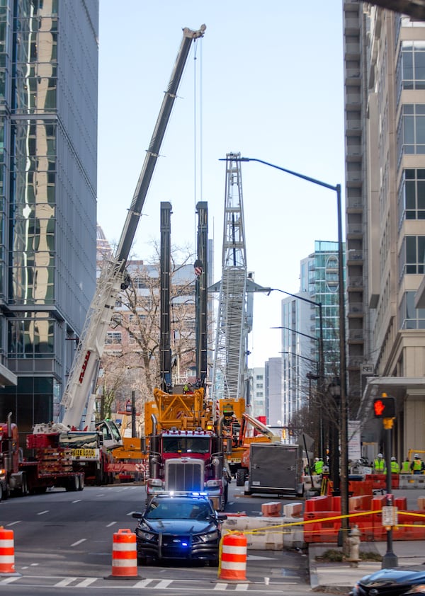 Heavy machinery was brought in to remove a teetering crane outside a Midtown high-rise on Saturday, February 20, 2021. (Photo: Steve Schaefer for The Atlanta Journal-Constitution)