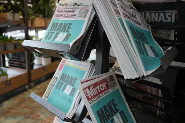 British newspapers are wrapped as a protest against the British government's planned changes to the law around artificial intelligence that would allow AI models to be more easily trained on copyrighted material, in London, Tuesday, Feb. 25, 2025. (AP Photo/Kin Cheung)