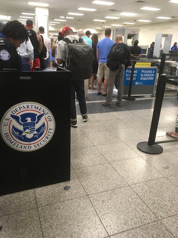 Security lines shut down and some bowed their heads during a moment of silence Wednesday morning. Photo: Jennifer Brett