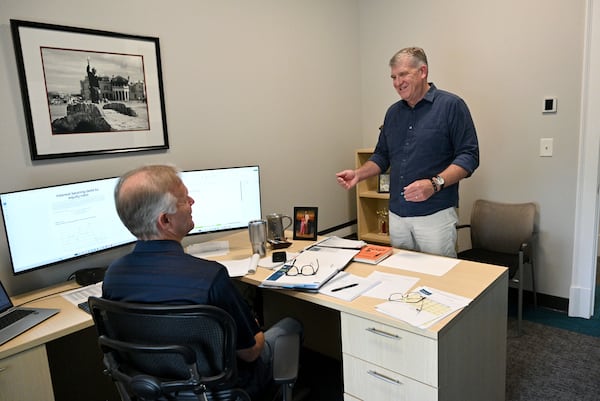 Mark Jackson (right), president of Kennesaw architecture and engineering firm Croft & Associates, talks with colleague Jeff Hassenboehler on Wednesday, June 5, 2024. The firm, like most Georgia companies, must file ownership information reports under a new federal law that could curb money laundering. (Hyosub Shin / AJC)