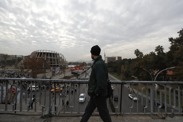 A man passes on a pedestrian bridge in Damascus, Syria, Saturday, Dec. 7, 2024. (AP Photo/Omar Sanadiki)