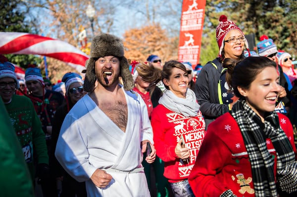 December 19, 2015 Atlanta - Wes Vaughn (left) takes off from the starting line during the Ugly Sweater Run at Piedmont Park in Atlanta on Saturday, December 19, 2015. Thousands of people donned their ugliest holiday themed gear to make their way through the course. JONATHAN PHILLIPS / SPECIAL