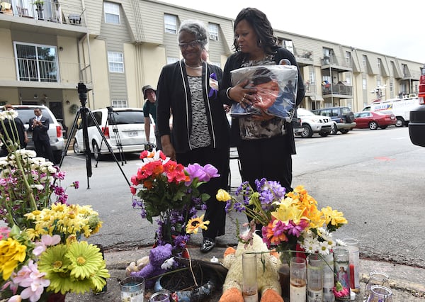 Mother of Anthony Hill, Carolyn Baylor-Giummo, right, and grandmother of Anthony Hill, Theola Baylor, look a memorial at the apartment complex where Anthony Hill, 26, was shot and killed by a DeKalb County police officer.  (HYOSUB SHIN / HSHIN@AJC.COM)