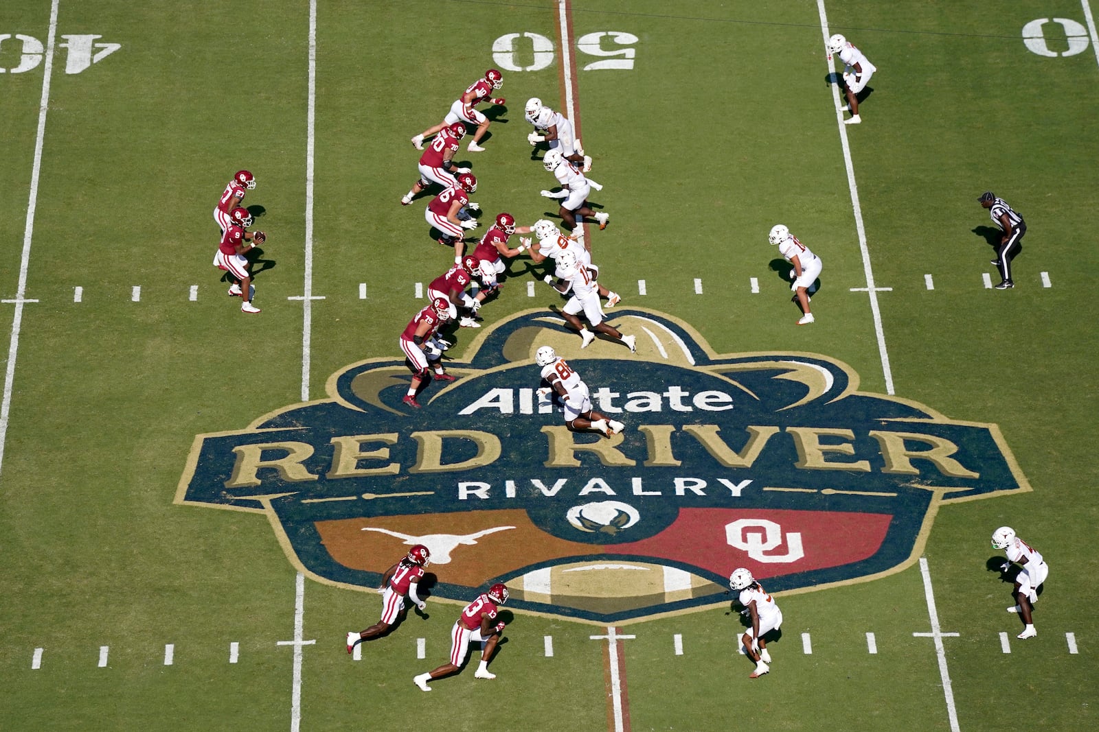 Oklahoma, left, and Texas, right, face off at the Cotton Bowl Stadium in the first half of an NCAA college football game in Dallas, Saturday, Oct. 12, 2024. (AP Photo/Jeffrey McWhorter)