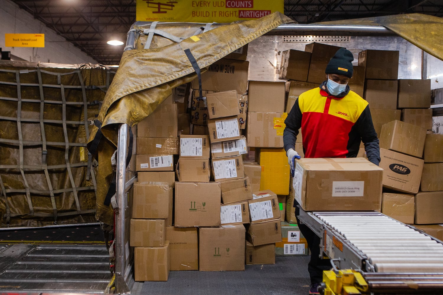 Milton Jones sorts packages on Wednesday, December 16, 2020, at DHL Express in Atlanta. Workers at the shipping center worked to fulfill orders during the holiday rush. CHRISTINA MATACOTTA FOR THE ATLANTA JOURNAL-CONSTITUTION.