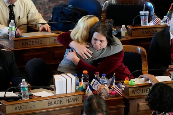 Rep. Aime Wichtendahl, D-Hiawatha, gets a hug after speaking during debate on the gender identity bill, Thursday, Feb. 27, 2025, at the Statehouse in Des Moines, Iowa. (AP Photo/Charlie Neibergall)