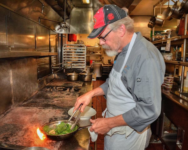 Chef Tenney Flynn prepares one of his recipes in the kitchen of Kyma in Buckhead. Flynn, who lives in New Orleans, but who was born and raised in Stone Mountain, Georgia, got his start with the Buckhead Life Restaurant Group. He has a new book out on fish and seafood, which is where the recipes come from. All photos taken Friday July 26, 2019 at Kyma in Buckhead. Food styling by Tenney Flynn. (Chris Hunt Photography)