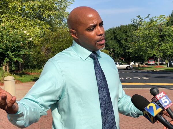 Robert Hawes speaks with reporters outside the Clayton County Courthouse on Thursday after his wife’s first appearance in Clayton Magistrate Court. 