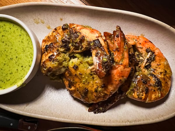 Delbar's Omani shrimp with green labneh are messy, spicy and fun to eat. Henri Hollis/henri.hollis@ajc.com