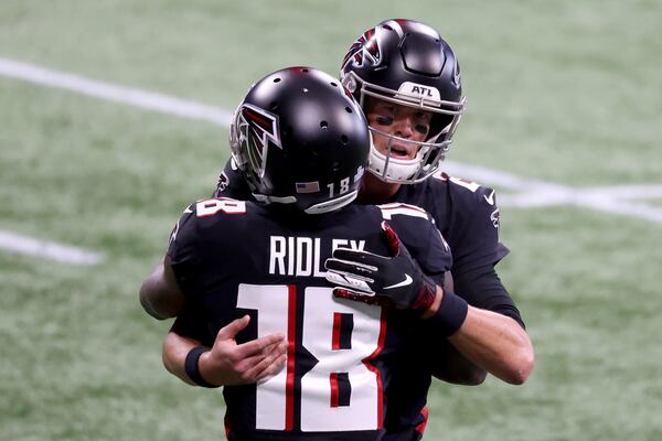 Falcons quarterback Matt Ryan greets wide receiver Calvin Ridley (18) on the field before their game against the Carolina Panthers Sunday, Oct. 11, 2020, at Mercedes-Benz Stadium in Atlanta. (Jason Getz/For the AJC)