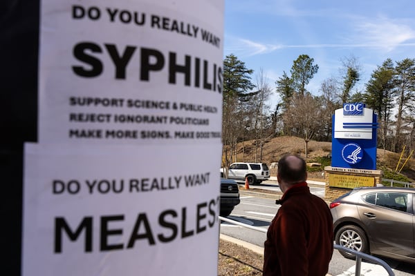 Demonstrators protest the mass firing of 1,000 Centers for Disease Control and Prevention employees in front of the CDC headquarters in Atlanta on Feb. 18. (Arvin Temkar/AJC)