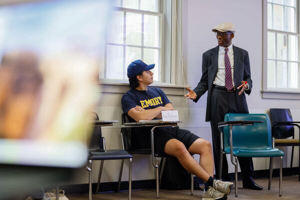 Emory University economics professor Melvin Ayogu discusses the economics of money laundering with first-year student Angel Acosta Leon as part of a new course, on Wednesday April 24, 2024.
(Miguel Martinez / AJC)