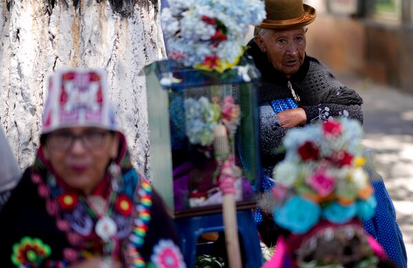 Women stand next to decorated human skulls at the General Cemetery as part of the annual "Ñatitas" festival, a tradition marking the end of the Catholic holiday of All Saints in La Paz, Bolivia, Friday, Nov. 8, 2024. (AP Photo/Juan Karita)